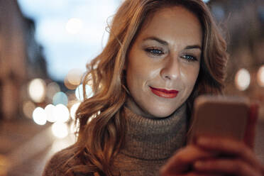 Blond woman using smart phone - JOSEF04429