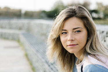 Beautiful blond woman looking away in skateboard park - XLGF01793