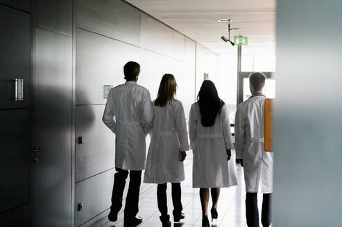 Weibliche und männliche Ärzte im Laborkittel gehen zusammen im Krankenhaus - BMOF00633