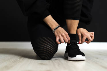 Female sportsperson tying shoelace - GIOF12671