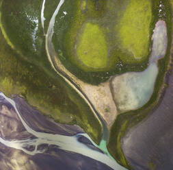 From above amazing view of river streaming on terrain covered with lush abundant vegetation in Iceland - ADSF24226