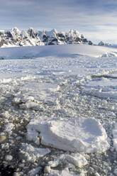 Snow-covered mountains and dense sea ice in Neumayer Channel, Palmer Archipelago, Antarctica, Polar Regions - RHPLF19708