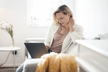 Smiling female professional working at home - JOSEF04537