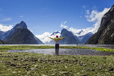 New Zealand, South Island, Milford Sound, Tourist enjoying mountain view - WVF01863