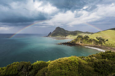 Der Regenbogen wölbt sich gegen die Gewitterwolken, die sich über der Küste der Coromandel-Halbinsel sammeln - WVF01949