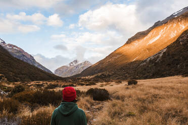 Male hiker standing and admiring beauty of Arthurs Pass, South Island, New Zealand - WVF01990