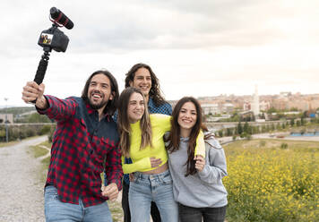 Male influencer vlogging with friends in nature - JCCMF02470