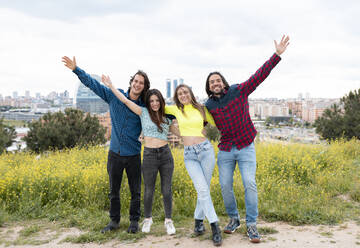 Male and female friends enjoying while standing in nature - JCCMF02481