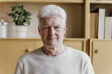 Senior man smiling at home - AFVF08781
