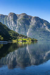 Mountain reflecting in clean water of Eid Fjord - RUNF04384