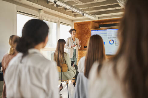 Female entrepreneur giving presentation to colleagues in conference event - AKLF00255