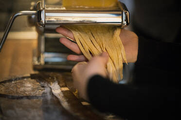 Woman preparing ribbon pasta at home - MJRF00451