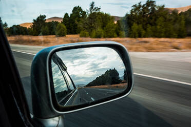 Side-view mirror reflection of car driving along State Highway 8 - WVF02014