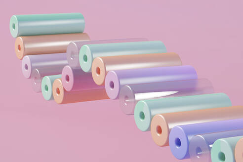 Dreidimensionales Rendering einer Reihe von pastellfarbenen Zylindern, die vor einem rosa Hintergrund schweben - JPSF00216