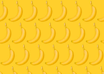 Pattern of rows of bananas lying against yellow background - FLMF00409