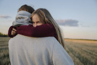 Daughter embracing father during sunset - EYAF01598