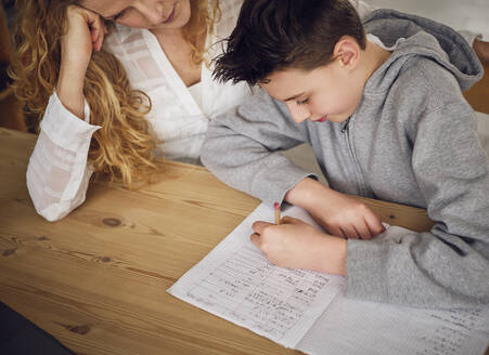 Son learning with mother while studying at home - PWF00343