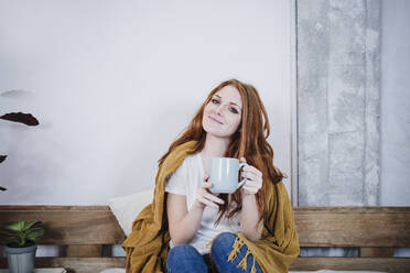 Young woman having coffee on bed - EBBF03553