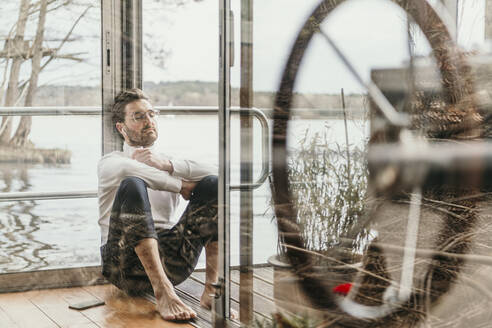 Tired man relaxing in houseboat - MJRF00519