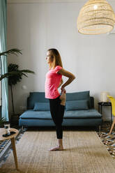 Young woman exercising at home - XLGF01907