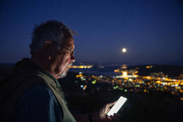 Senior man using mobile phone at Trogir, Croatia - MAMF01825