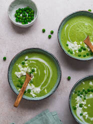 Top view of delicious pea cream soup in bowls served on table with napkin - ADSF24601
