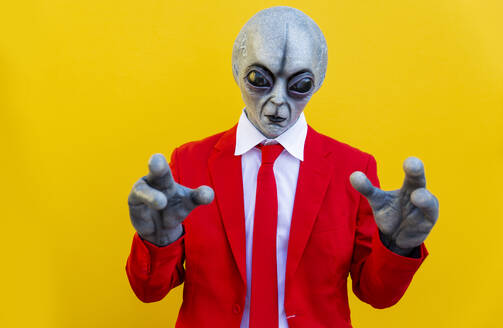 Portrait of man wearing alien costume and bright red suit - OIPF00679