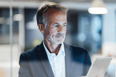 Senior male entrepreneur using digital tablet in office - GUSF05794