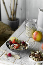 Healthy breakfast: muesli, fruit, milk on rustic wooden tray - ASF06762