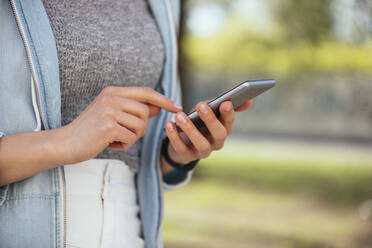 Woman using mobile phone at outdoors - OYF00371