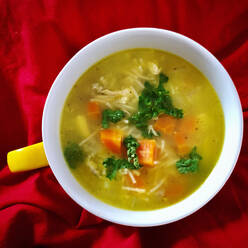 Bowl of ready-to-eat chicken soup with carrot and parsley - PUF01977