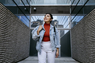 Young woman smiling while looking up - TCEF01861