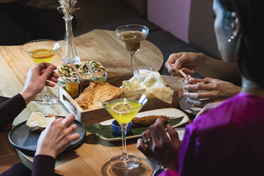 Friends having food and drink at restaurant - PNAF01707