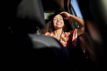 Young woman traveling in car during road trip - KIJF03889