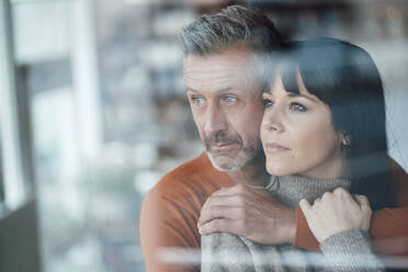 Thoughtful couple looking away at cafe - JOSEF04641