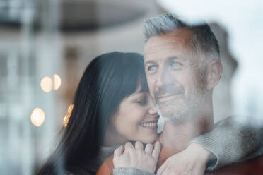 Smiling woman leaning on man with arm around at cafe - JOSEF04644