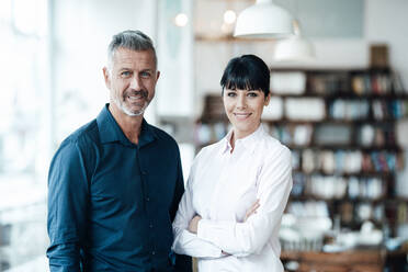 Confident male and female owners standing together at cafe - JOSEF04733