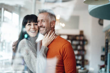 Smiling woman standing by man at cafe - JOSEF04757