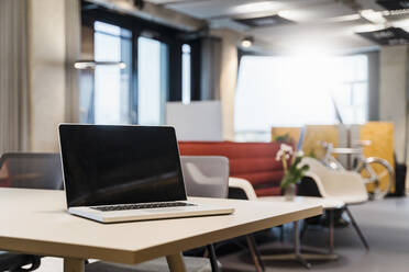 Laptop placed on desk in creative office - DIGF15661