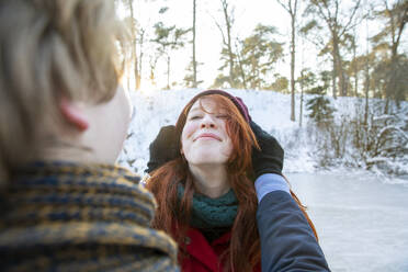 Smiling girlfriend enjoying weekend with boyfriend during winter - FVDF00202