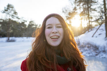 Smiling redhead woman during winter - FVDF00208