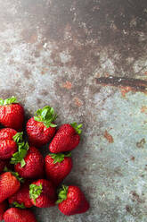 Fresh ripe strawberries lying on metal surface - GIOF12728