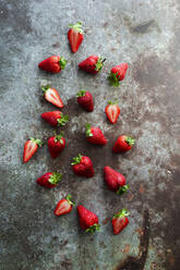 Fresh ripe strawberries lying on metal surface - GIOF12729