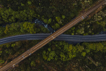 Aerial view of highway stretching under old viaduct - RSGF00714