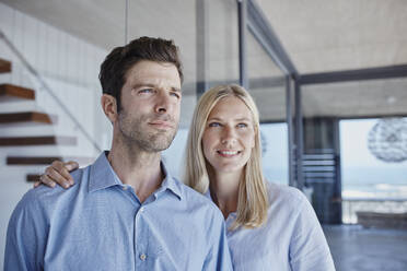 Mid adult man and woman standing together while looking away - RORF02771