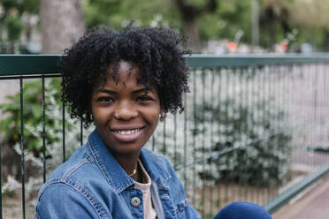 Smiling young woman with Afro hairstyle and nose ring - XLGF01994