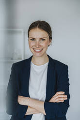 Smiling businesswoman with arms crossed - MFF07961