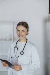 Female healthcare worker holding digital tablet - MFF07969
