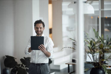 Male entrepreneur using digital tablet at office - GUSF06025