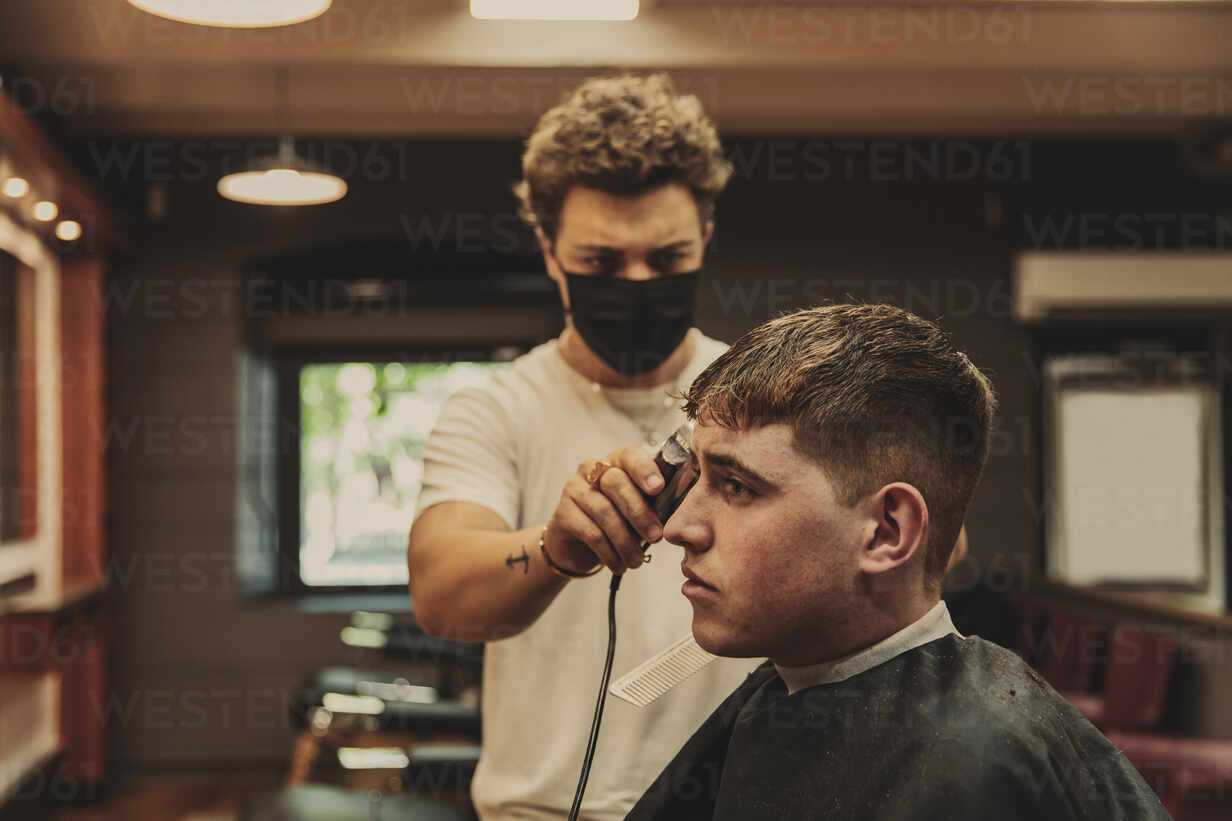 Man Getting His Hair Cut at a Barber Shop · Free Stock Photo